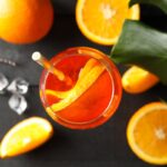 Composition with aperol spritz cocktail on wooden background, top view